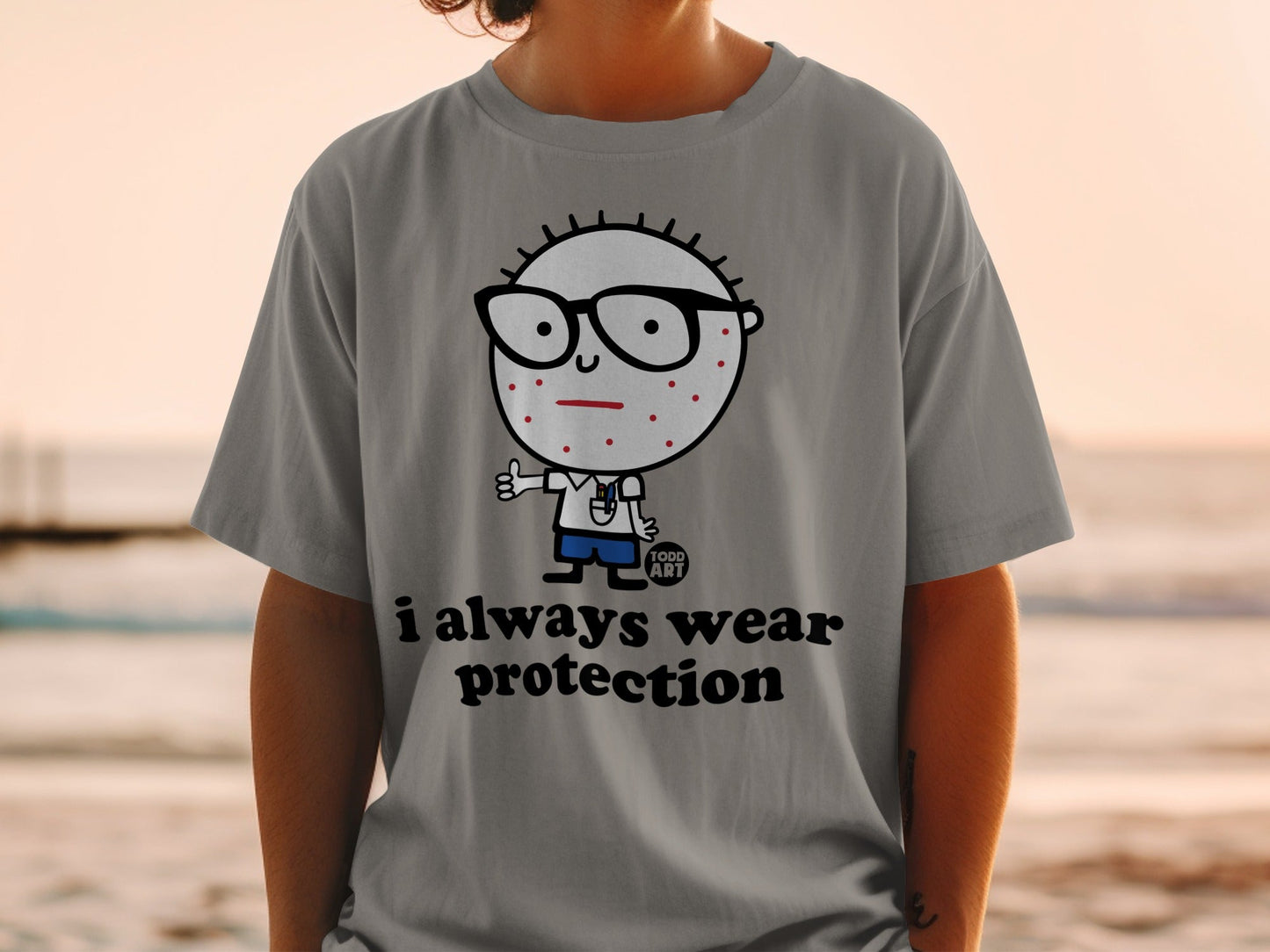 Gray t-shirt with cartoon character and "i always wear protection" text.