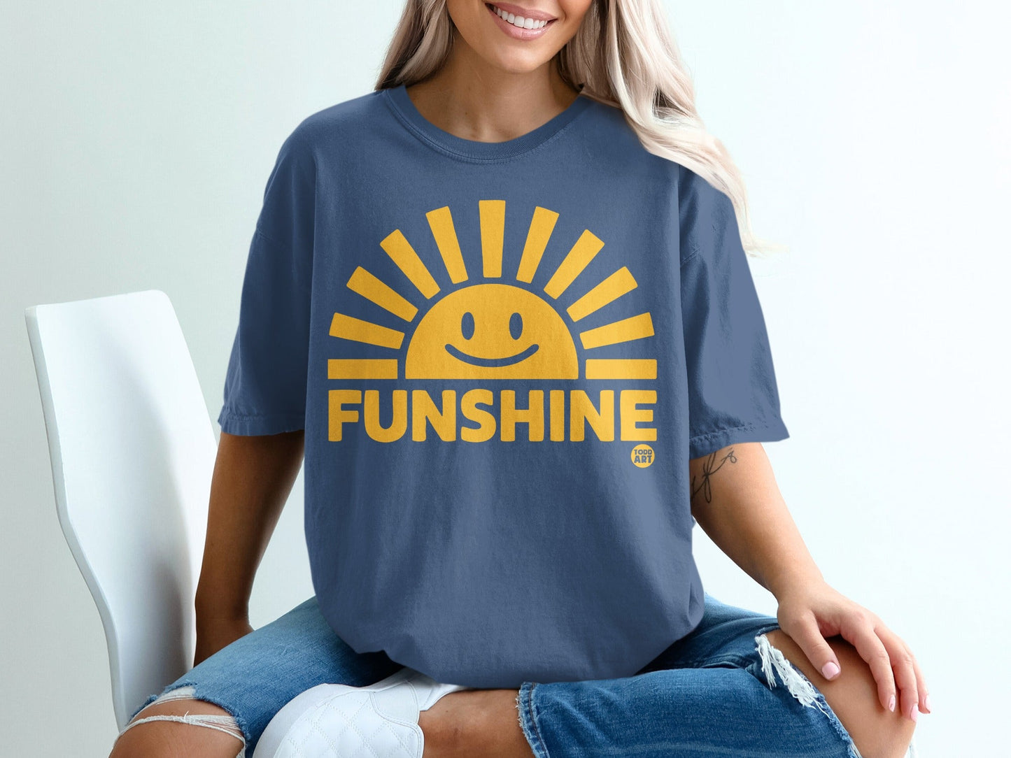 Blue t-shirt with yellow smiling sun and "FUNSHINE" text.