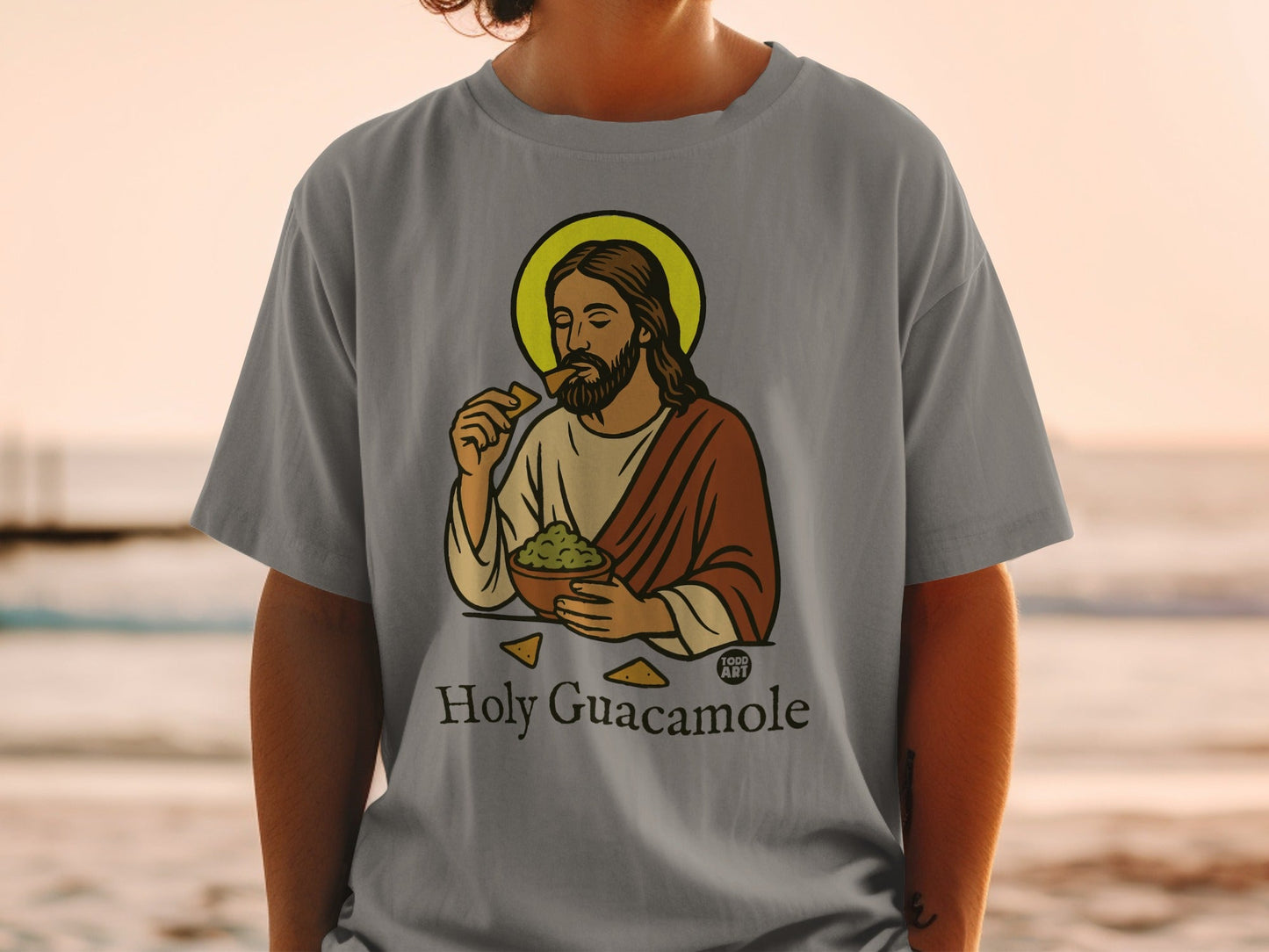 Jesus eating guacamole from a bowl on a grey t-shirt.