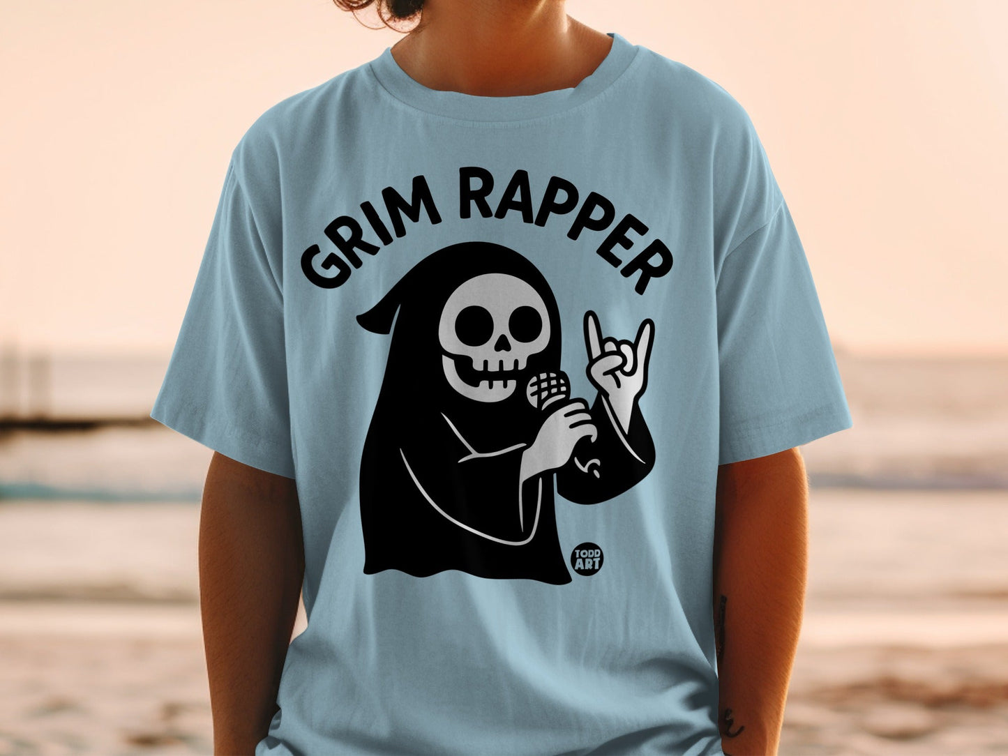 Light blue t-shirt with black grim reaper graphic and "Grim Rapper" text.