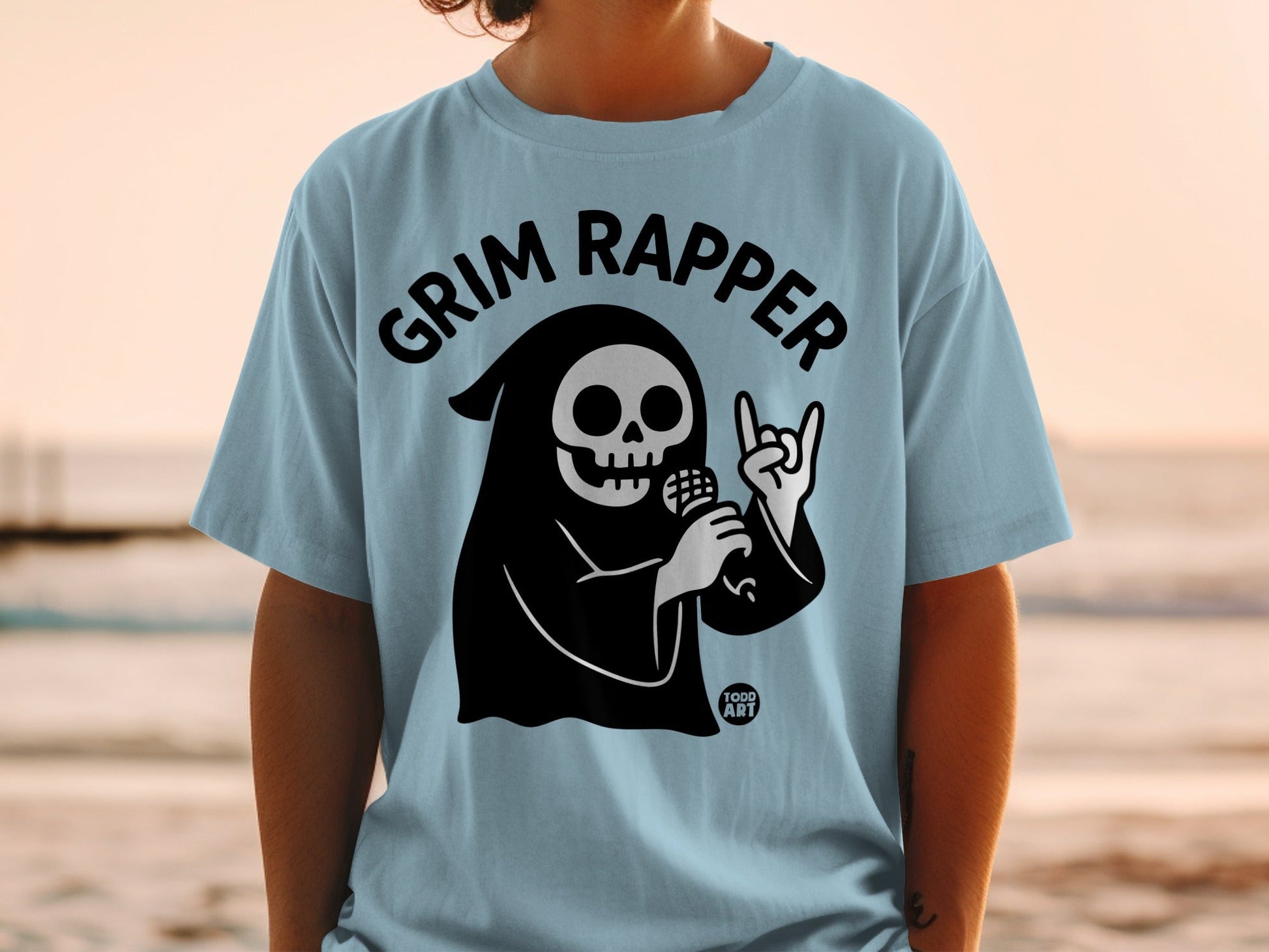 Light blue t-shirt with black grim reaper graphic and "Grim Rapper" text.