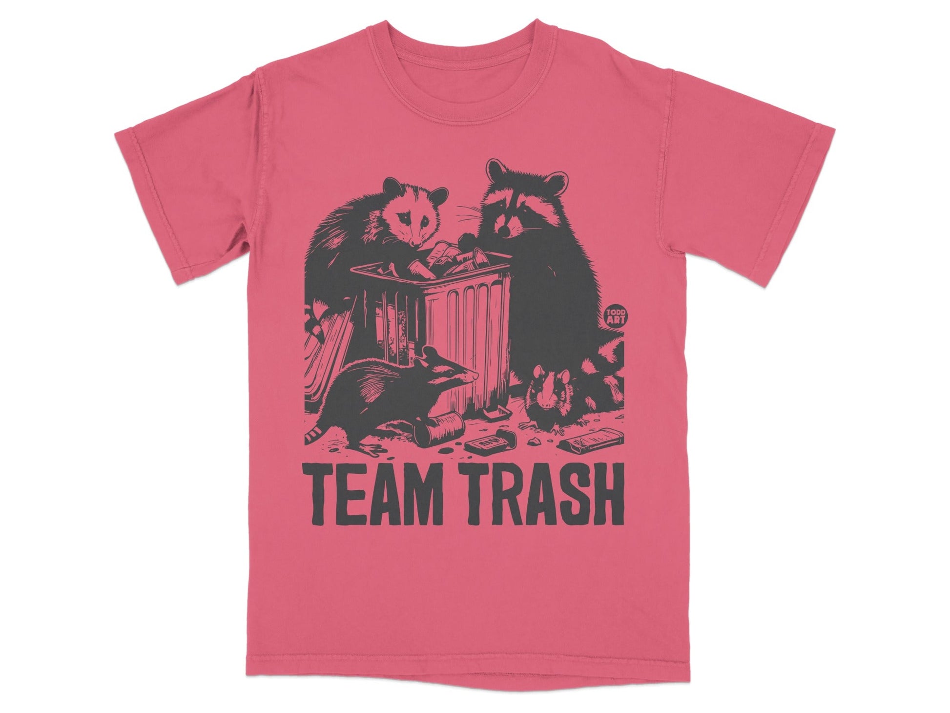 T-shirt with cartoon raccoons and opossum around a trash can.