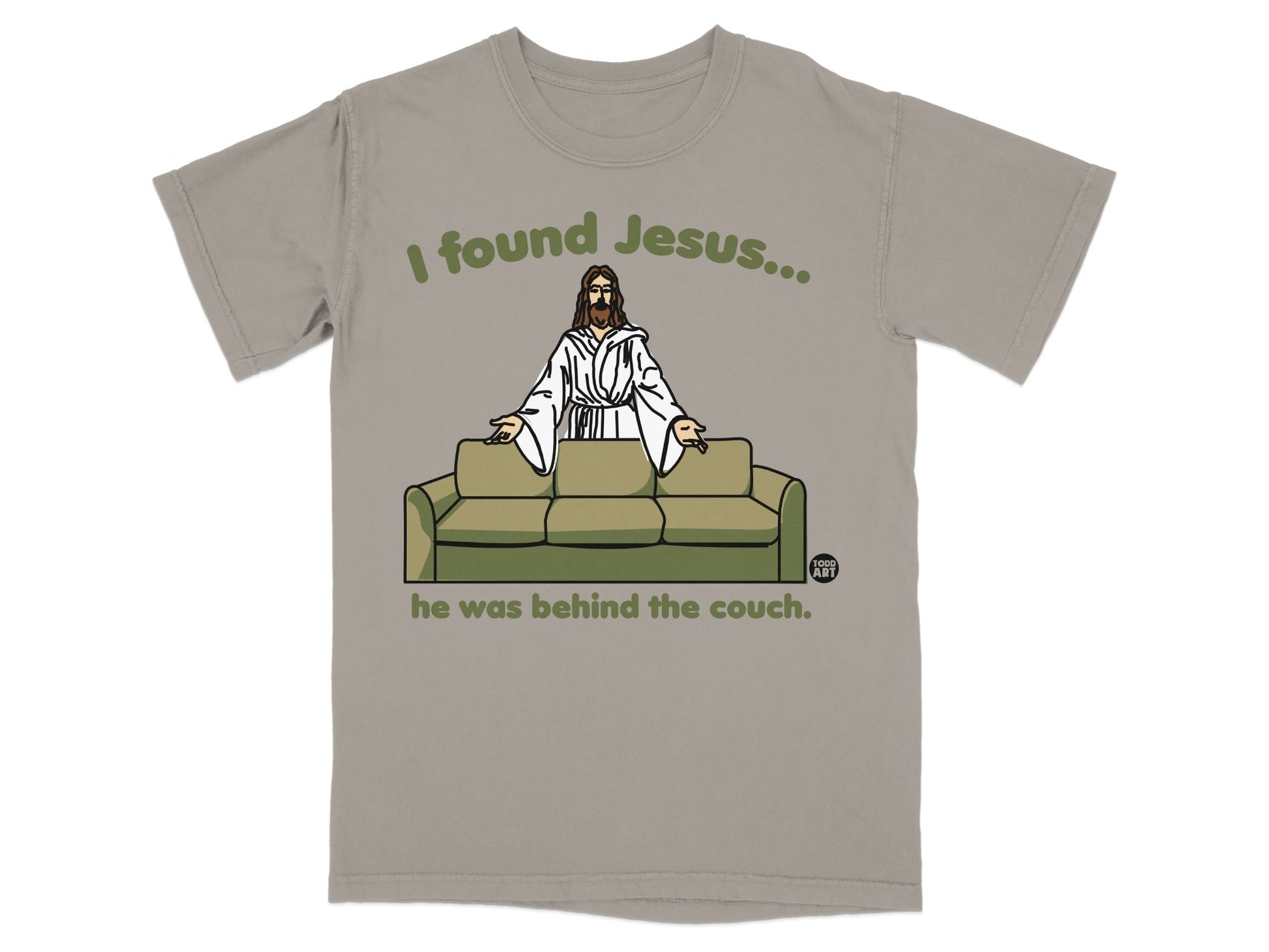 T-shirt with "I found Jesus... he was behind the couch" text and illustration.