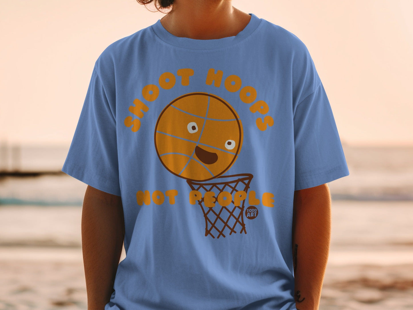 Blue t-shirt with text "SHOOT HOOPS" and cartoon basketball in net.