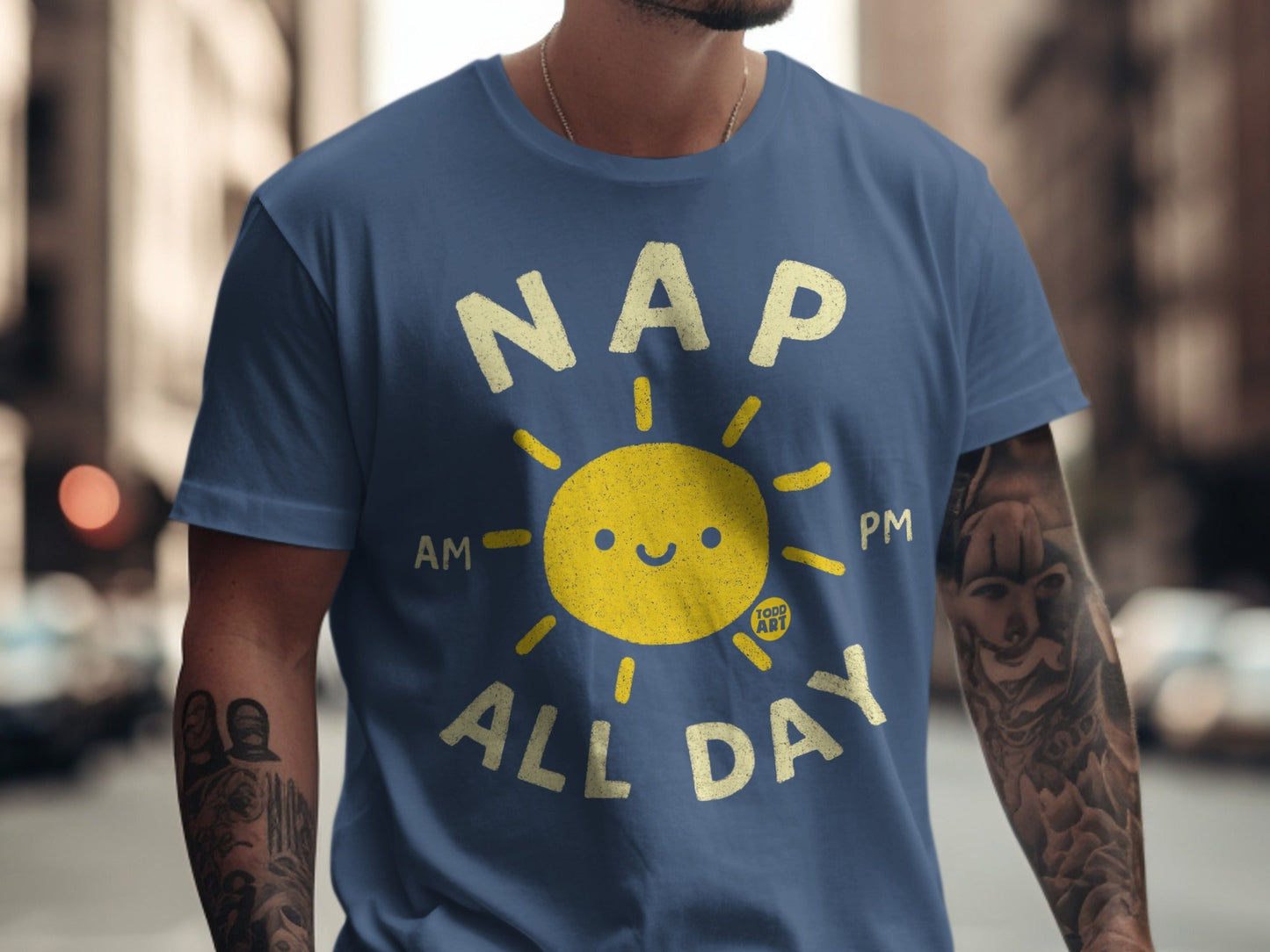 Blue t-shirt with smiling sun graphic and "NAP AM PM ALL DAY" text.