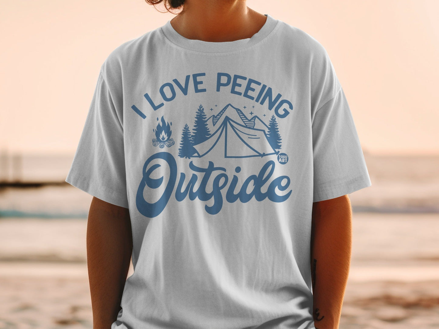 White t-shirt with blue text and graphics saying "I Love Peeing Outside" and a tent.