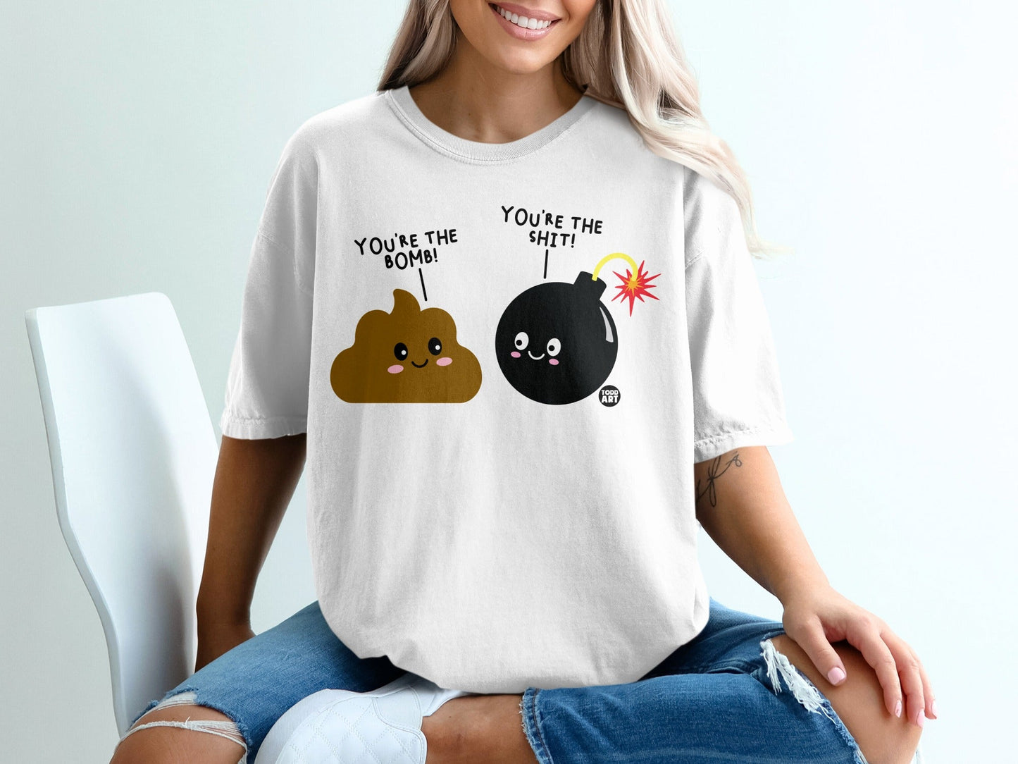 T-shirt with cartoon poop and bomb characters, "You're the bomb!" and "You're the shit!" text.