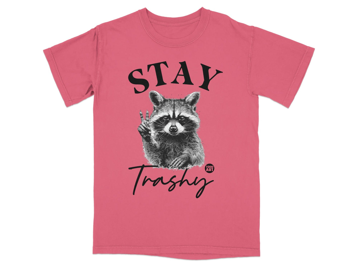 Coral t-shirt with a raccoon holding up a peace sign and the text "STAY Trashy".