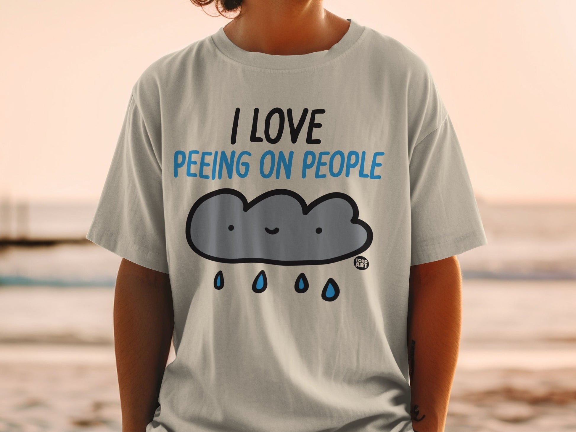 Light grey t-shirt with a cartoon cloud saying "I love peeing on people."
