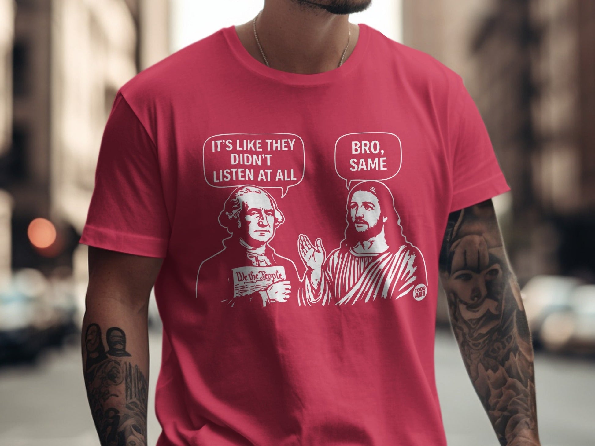 Red t-shirt with cartoon George Washington and Jesus discussing "We the People."