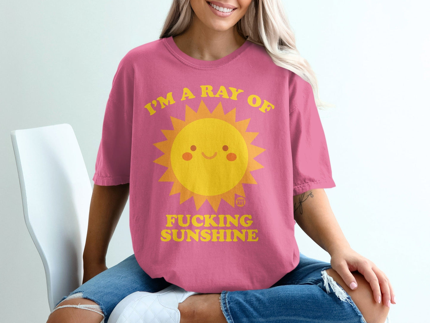 Pink t-shirt with a smiling sun graphic and text "I'M A RAY OF FUCKING SUNSHINE".