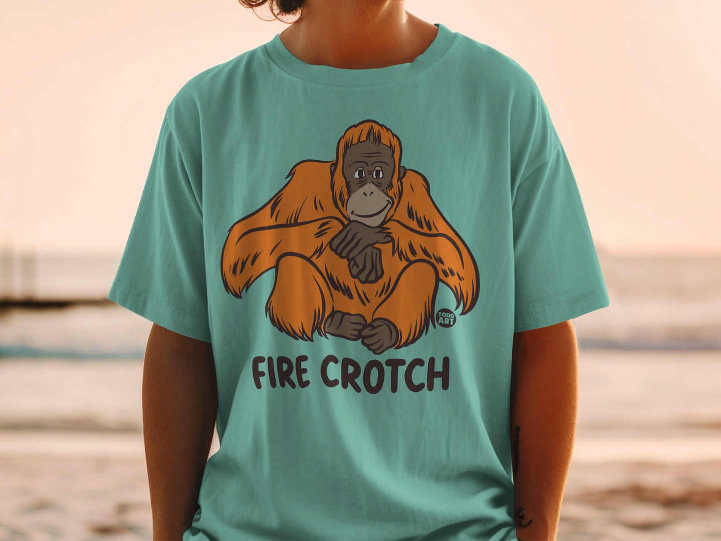 Teal t-shirt with orangutan graphic and "FIRE CROTCH" text.