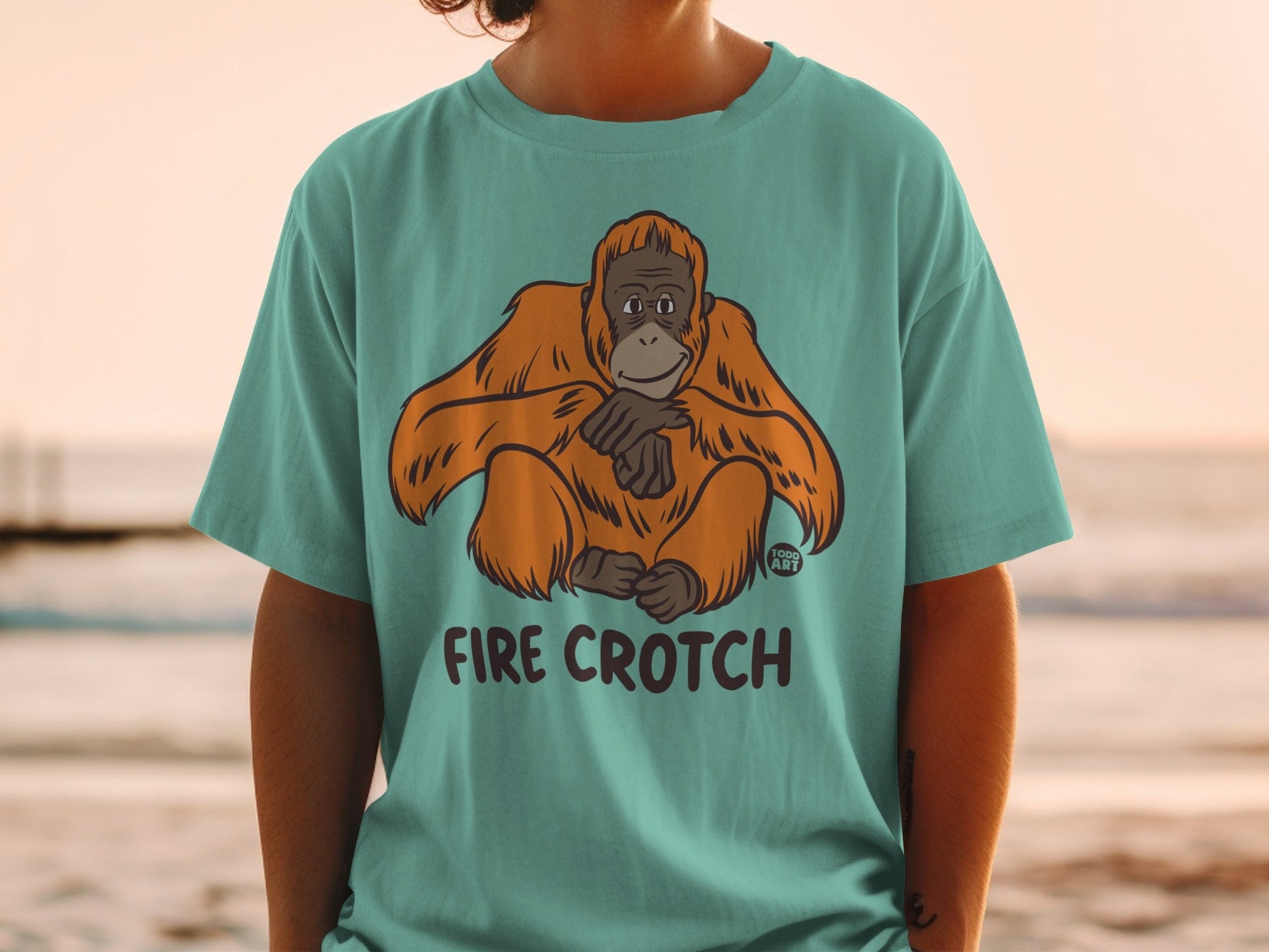 Teal t-shirt with orangutan graphic and "FIRE CROTCH" text.