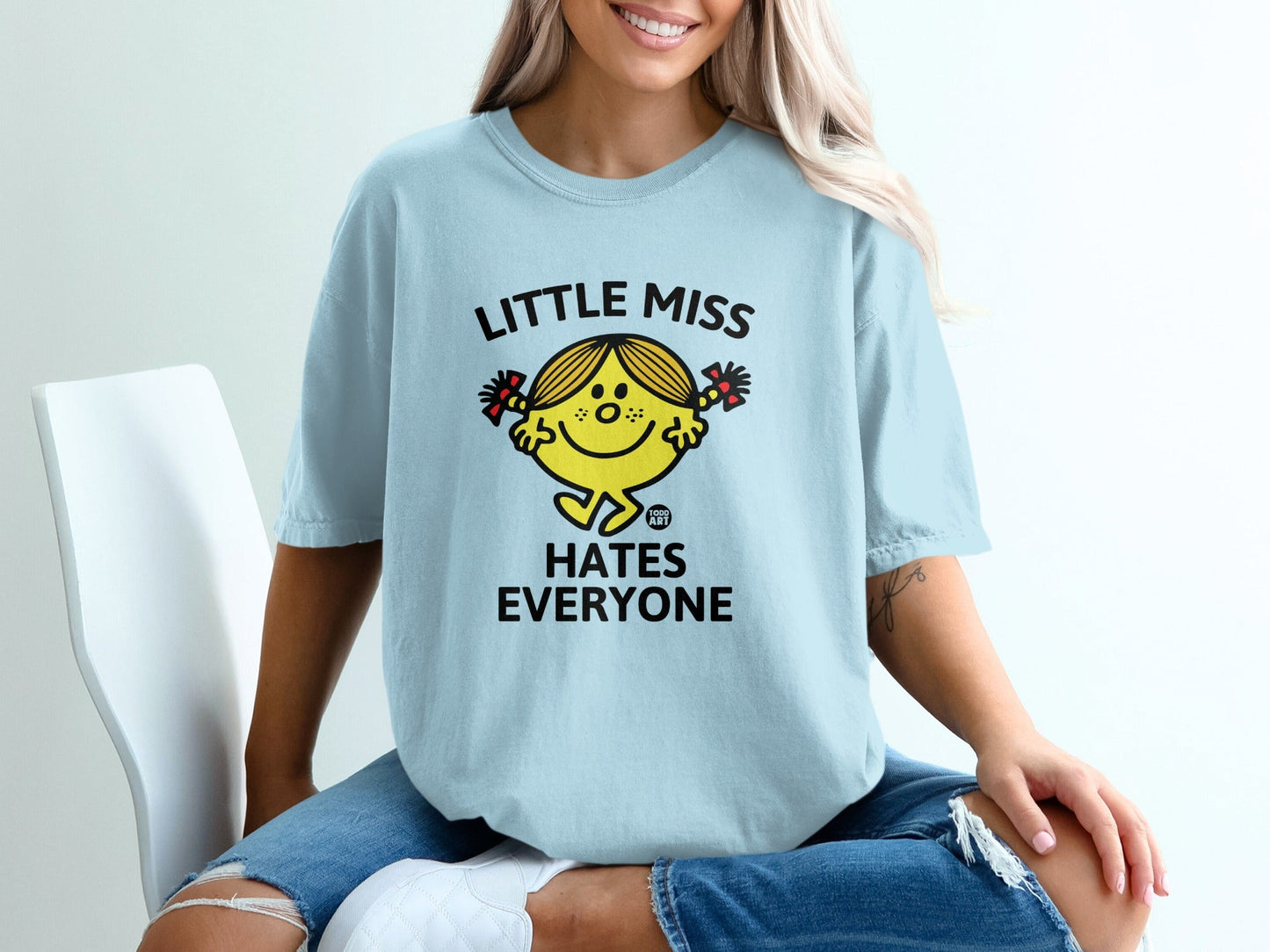 Light blue t-shirt with "Little Miss Hates Everyone" text and character.