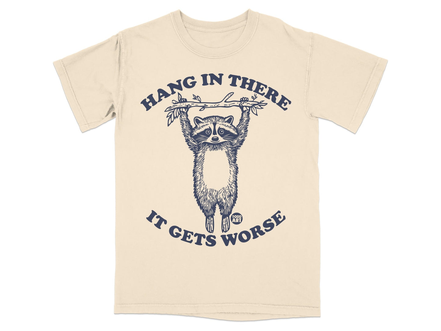 T-shirt with raccoon hanging from branch, text "Hang in there, it gets worse."