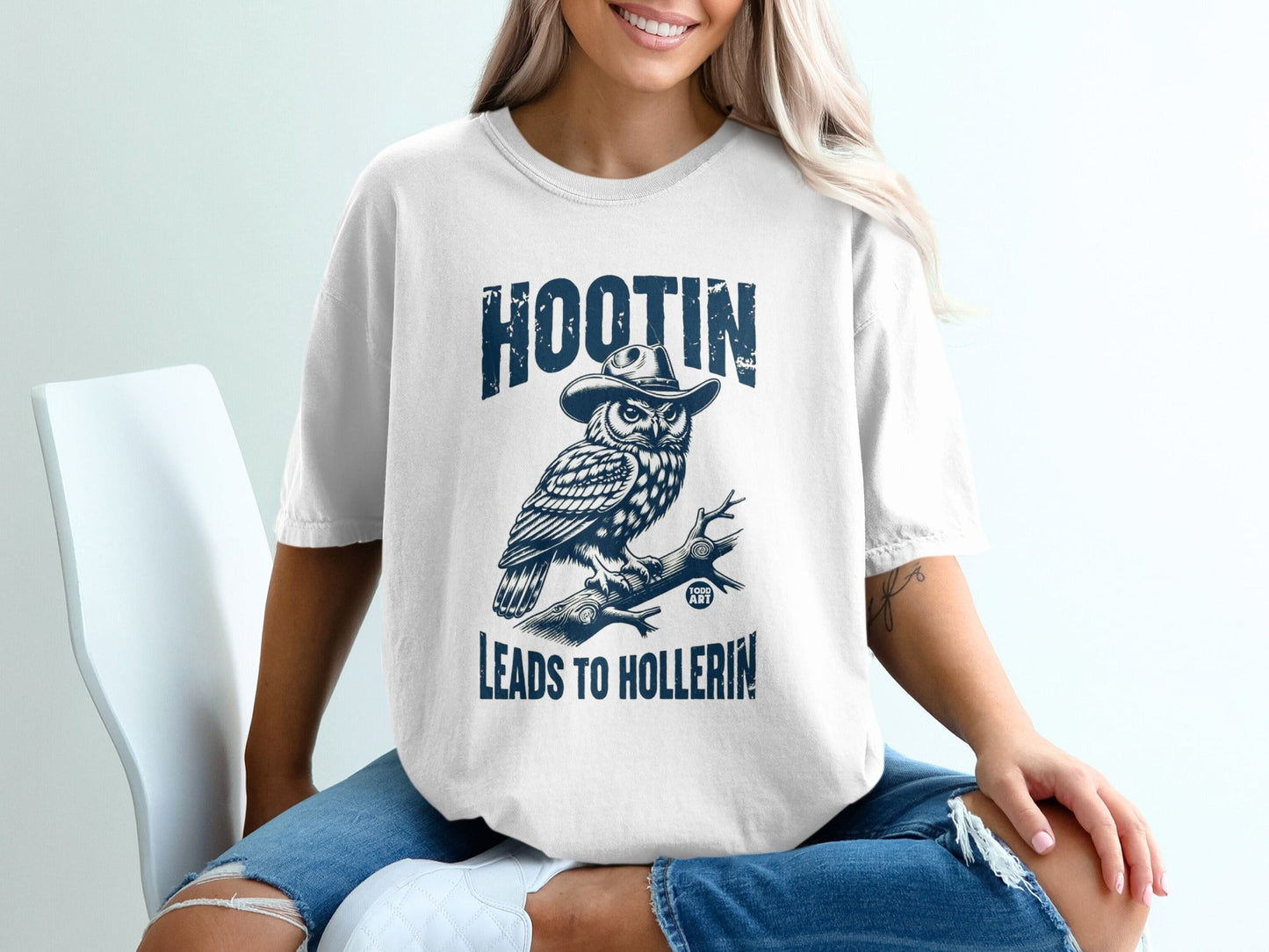 White t-shirt with "HOOTIN' LEADS TO HOLLERIN'" and owl graphic.
