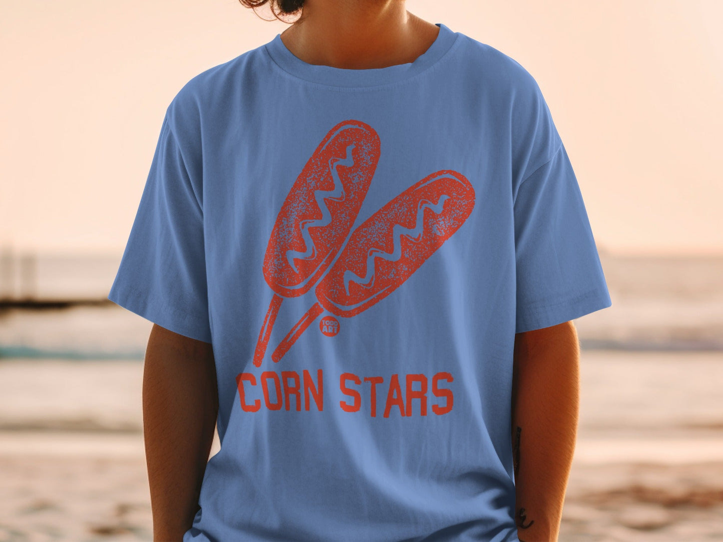 Blue t-shirt with orange corn dog graphic and "CORN STARS" text.
