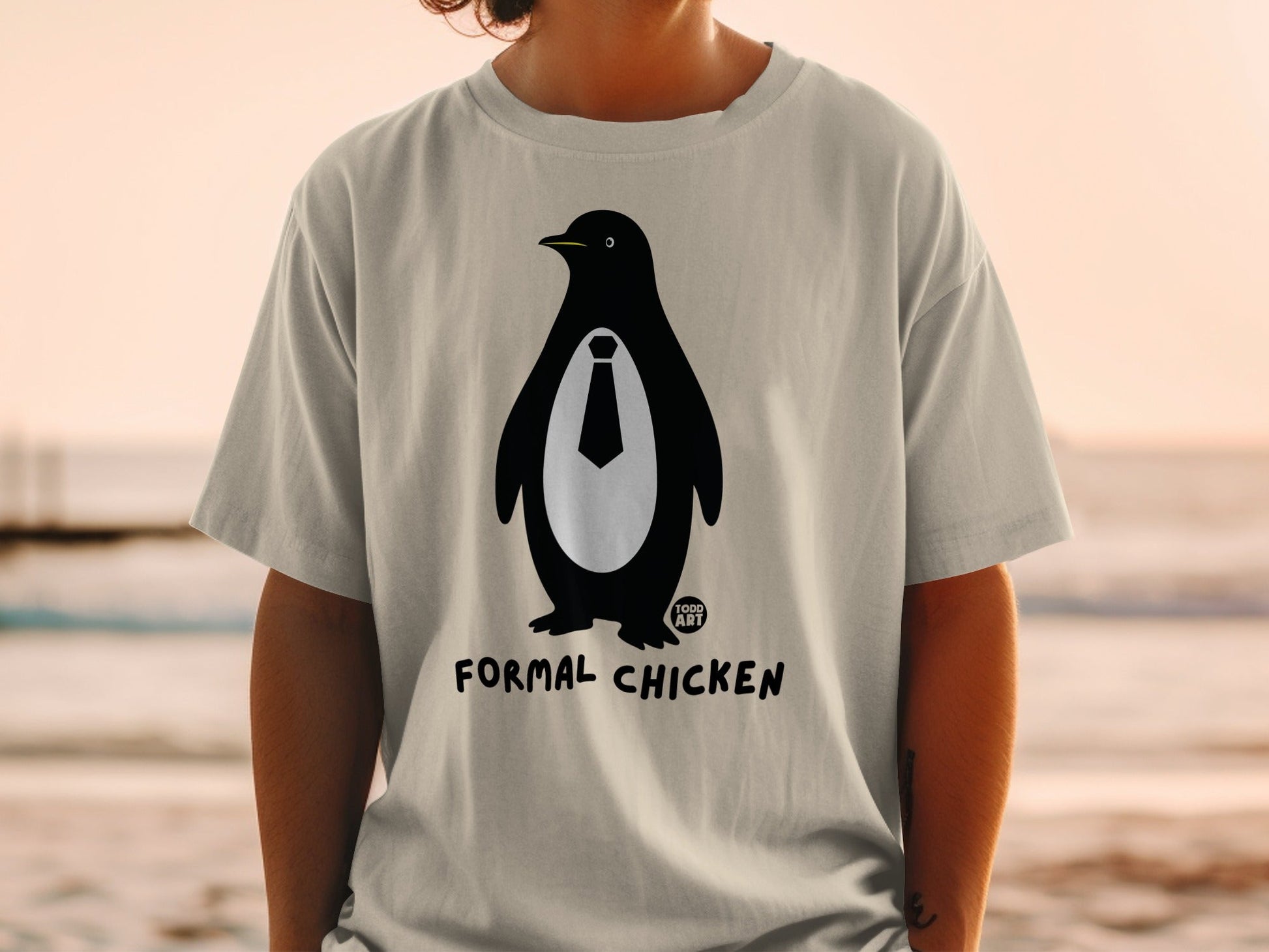 Penguin wearing a tie on a t-shirt with "FORMAL CHICKEN" text.