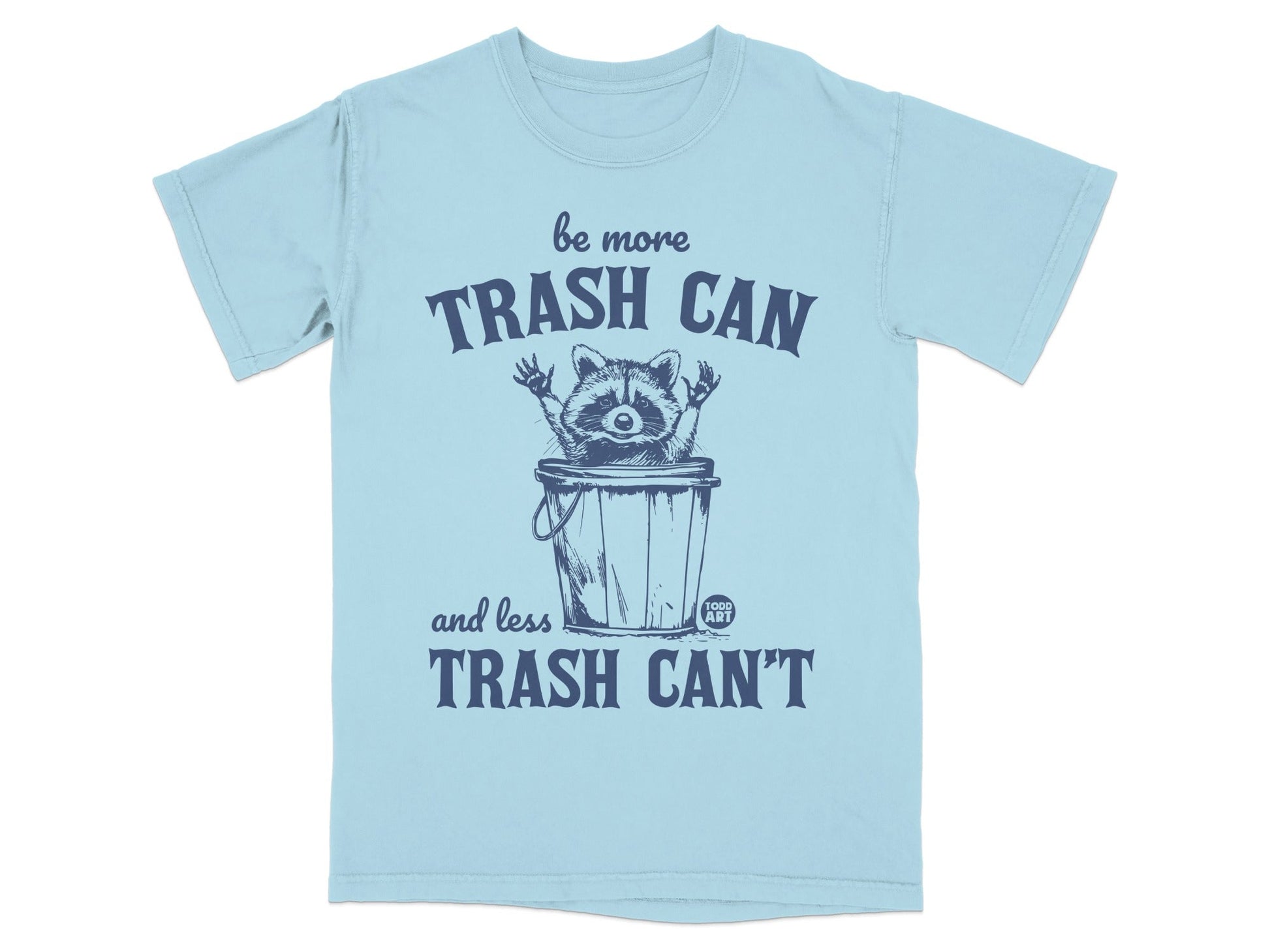 Light blue t-shirt with raccoon and "Be More Trash Can and Less Trash Can't" text.