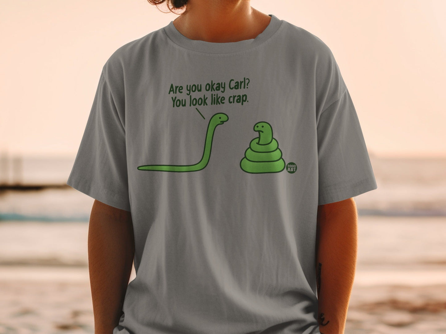 Grey t-shirt with green snakes and text: "Are you okay Carl? You look like crap."