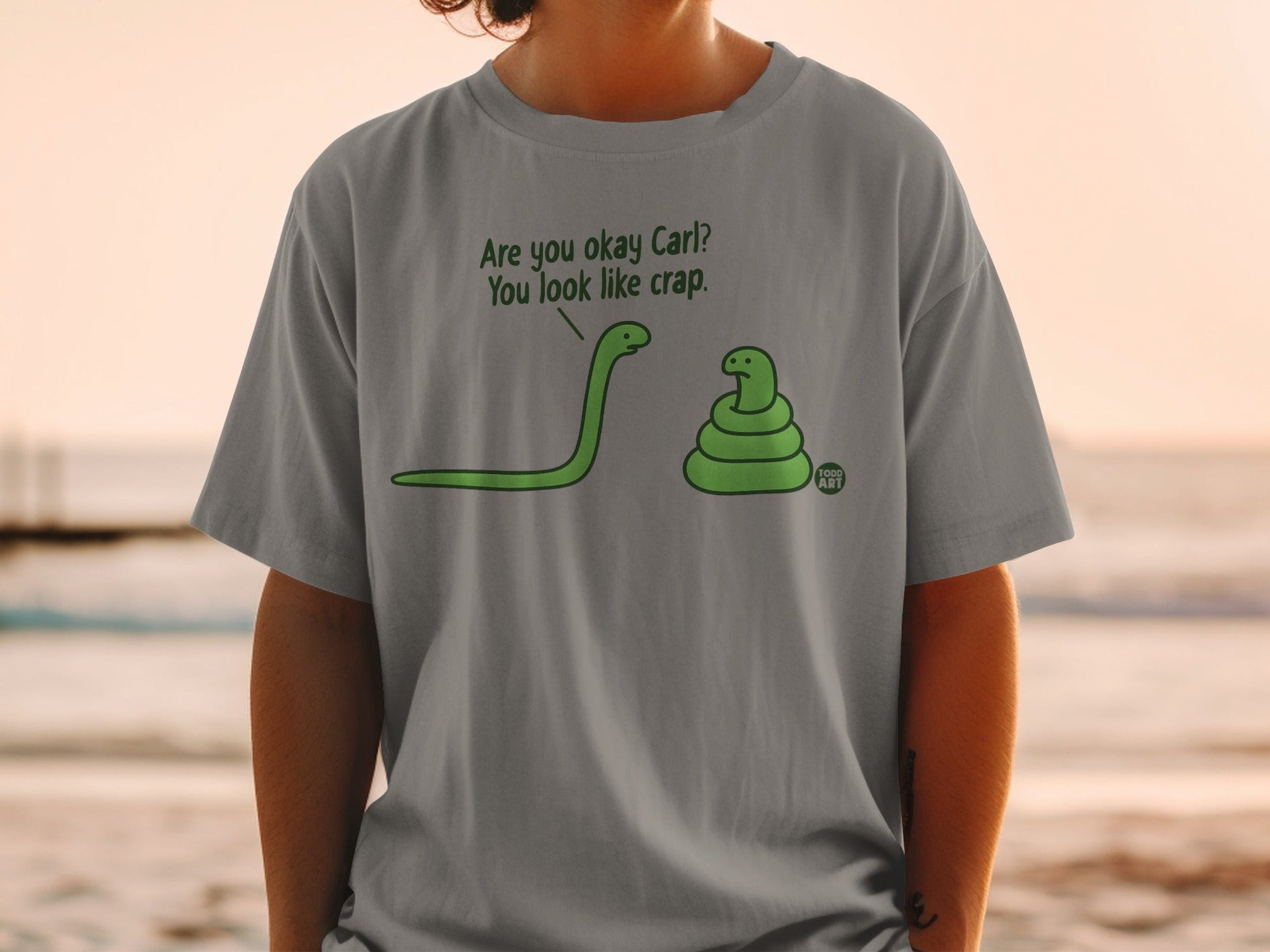 Grey t-shirt with green snakes and text: "Are you okay Carl? You look like crap."