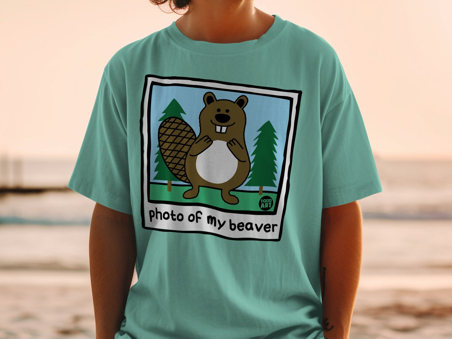 T-shirt with cartoon beaver in forest scene and text "photo of my beaver".