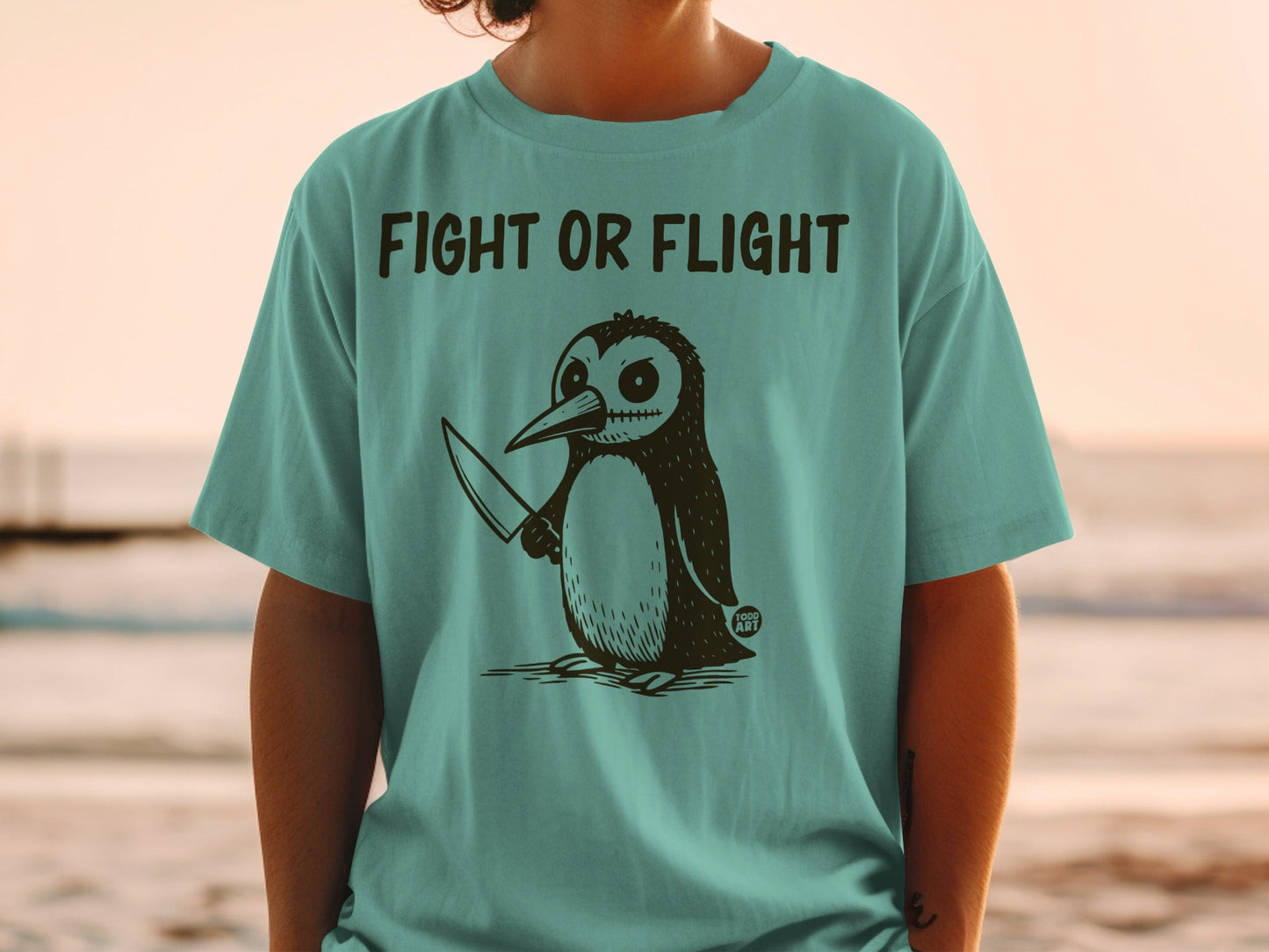 T-shirt with a cartoon penguin holding a knife and the text "FIGHT OR FLIGHT".