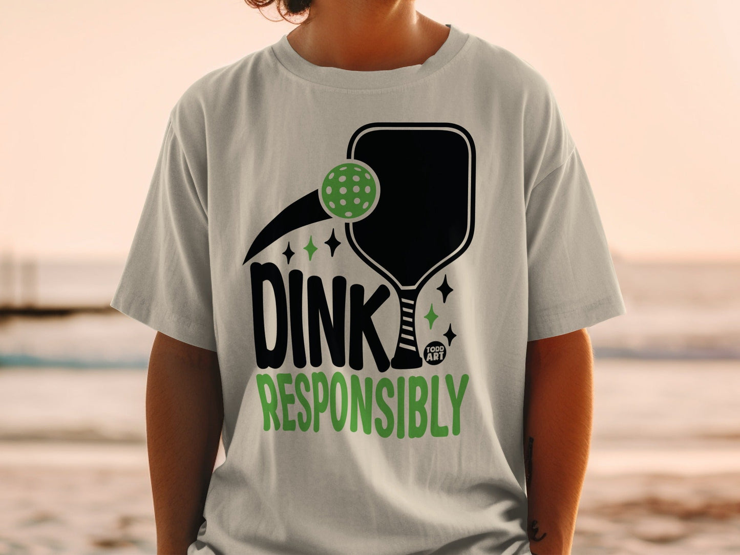 Pickleball paddle with a ball and "Dink Responsibly" text.