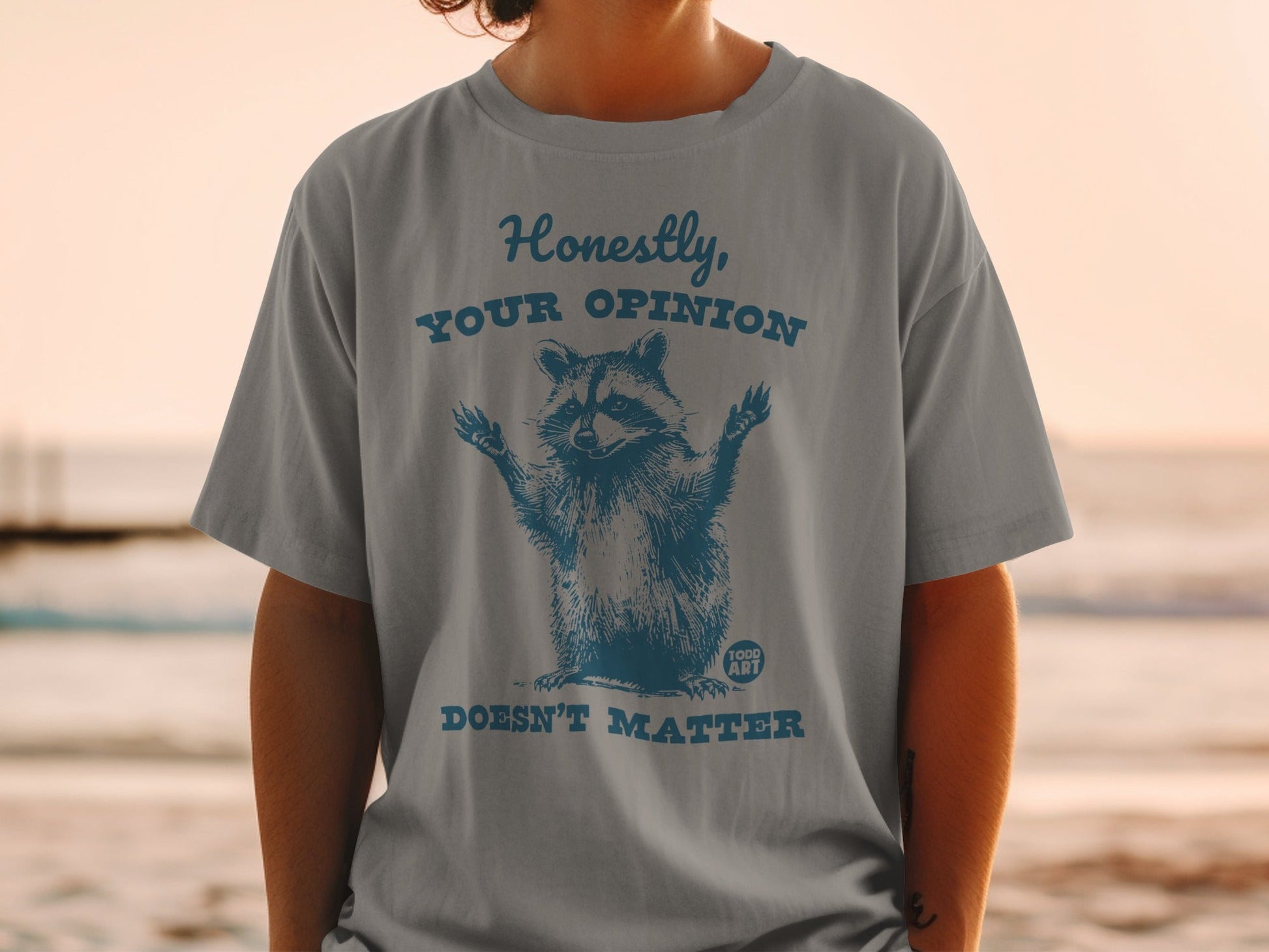 Graphic t-shirt with raccoon saying "Honestly, your opinion doesn't matter."