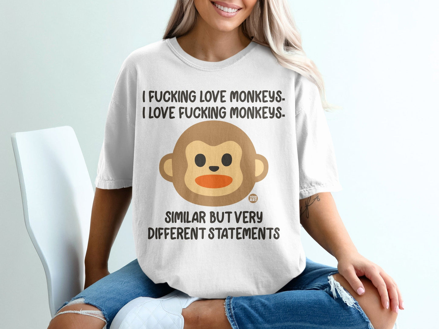 White t-shirt with a cartoon monkey and text about loving monkeys.