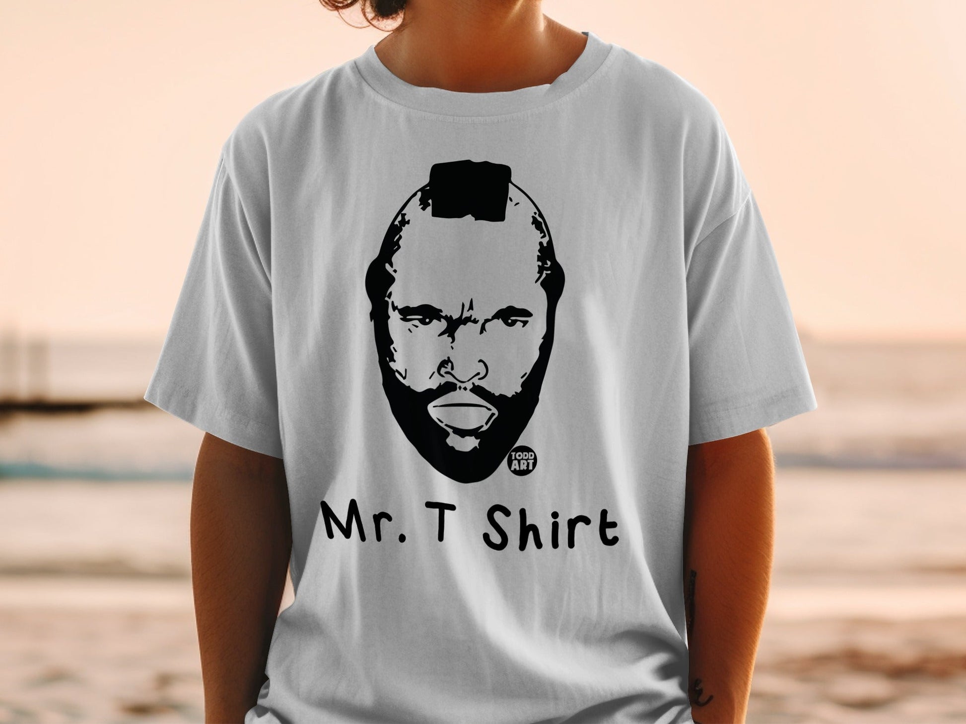 White t-shirt with Mr. T art and text "1000 ART" and "Mr. T SHIRT".