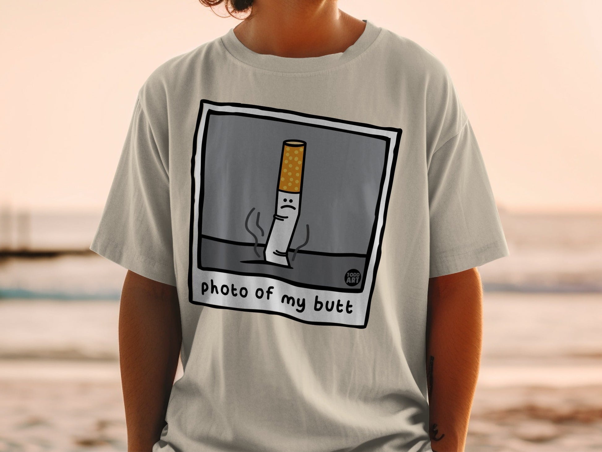 T-shirt with cartoon cigarette illustration and "photo of my butt" text.