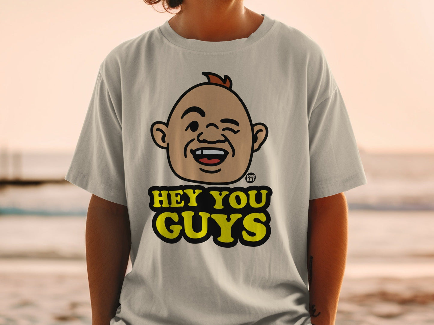 T-shirt with a cartoon character's face and the text "HEY YOU GUYS".