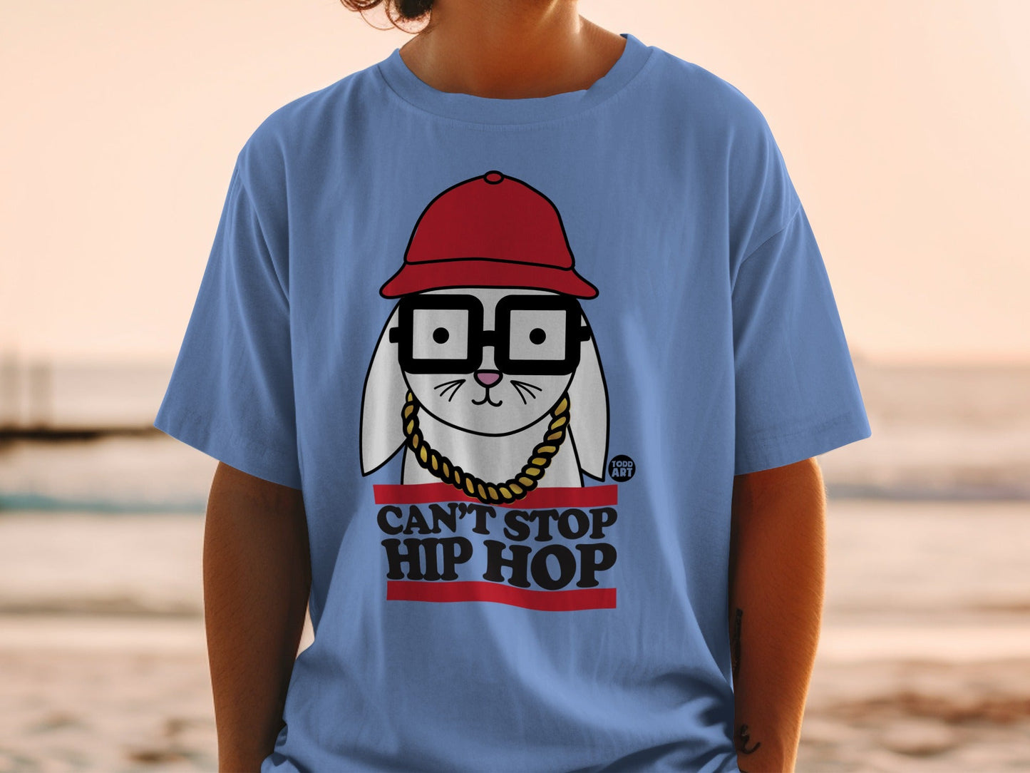 Blue t-shirt featuring a cartoon rabbit wearing glasses, red hat, and gold chain.