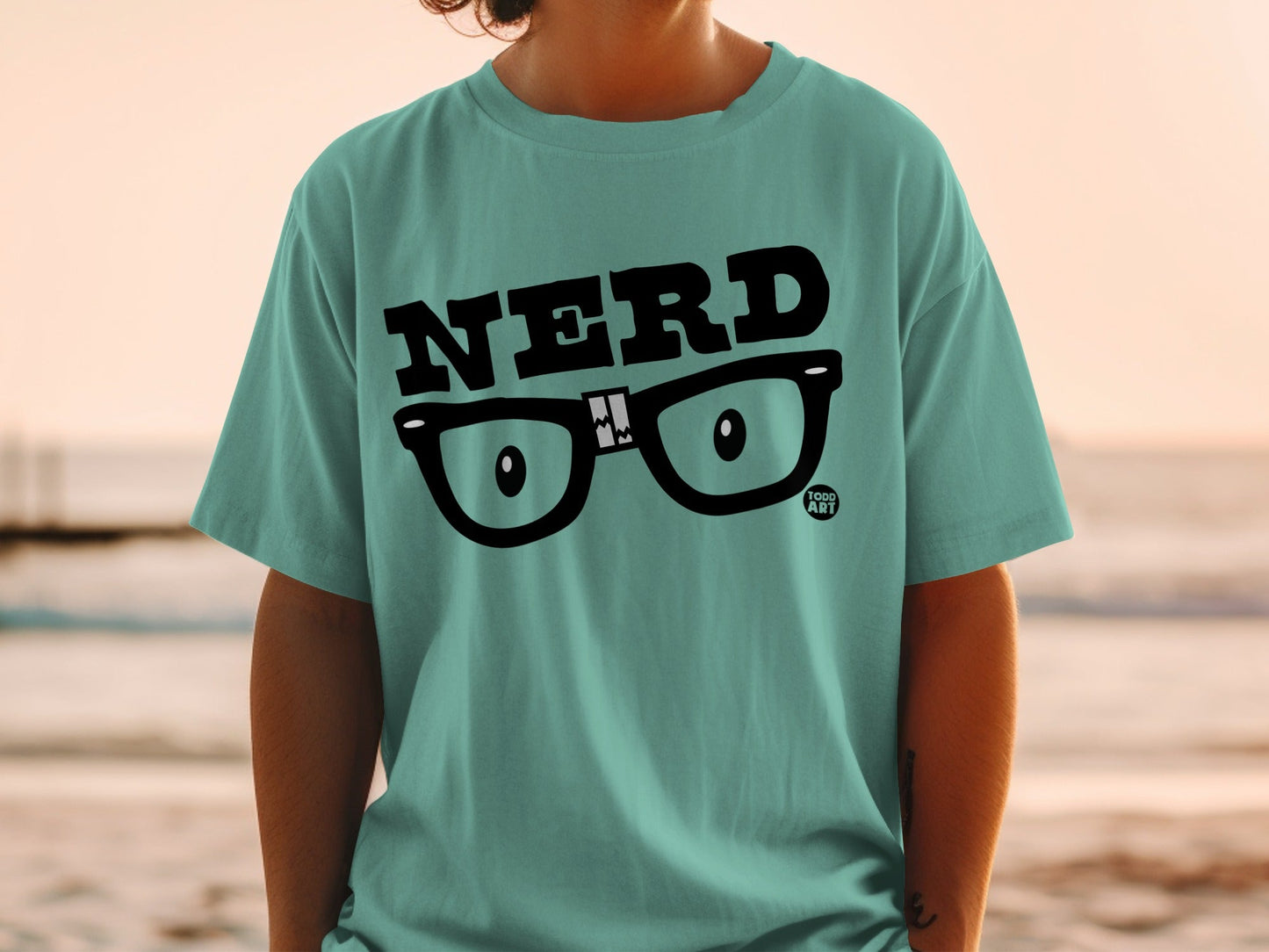 Teal t-shirt with "NERD" text and glasses graphic.