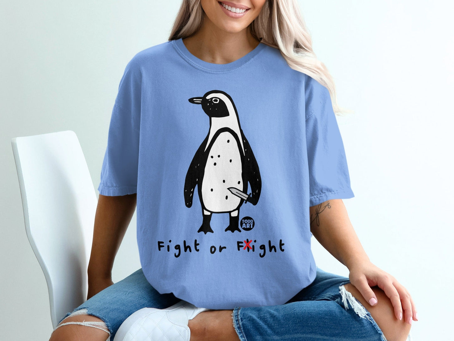Blue t-shirt with penguin holding a knife and the text "Fight or Flight".