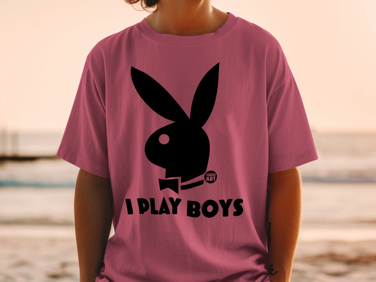 Pink t-shirt with black Playboy bunny logo and "I PLAY BOYS" text.