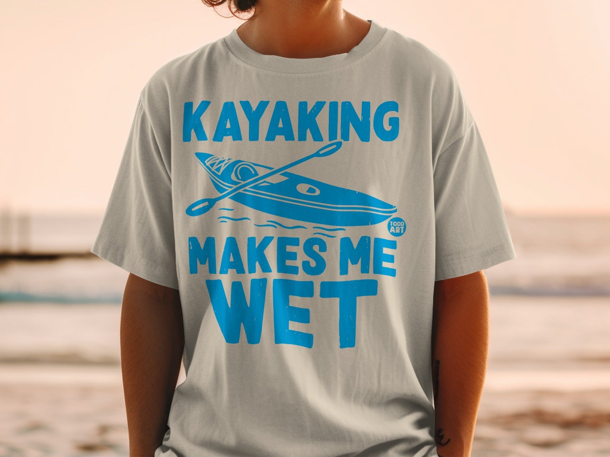 Light blue t-shirt with "Kayaking Makes Me Wet" and kayak graphic.