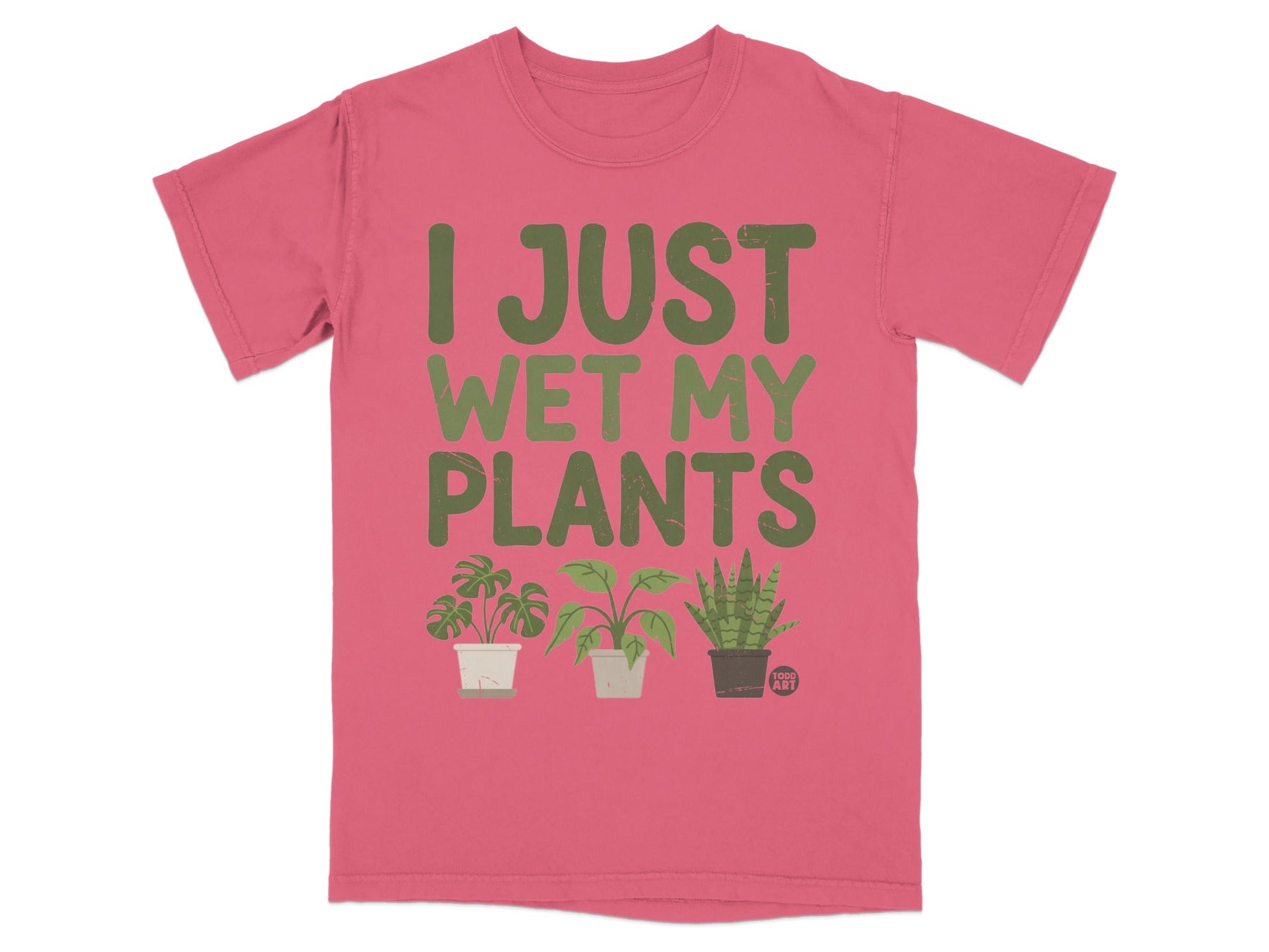 Pink t-shirt with green text "I JUST WET MY PLANTS" and three small potted plants.