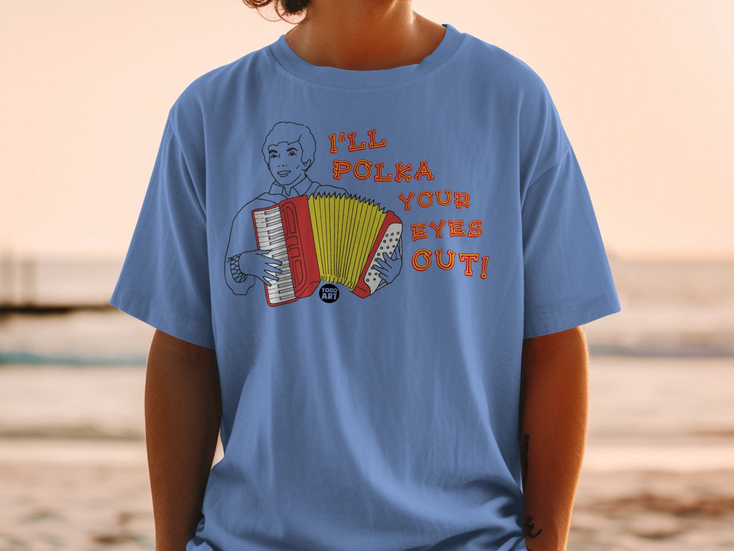 T-shirt with illustration of a man playing an accordion and text "I'LL POLKA YOUR EYES OUT!".