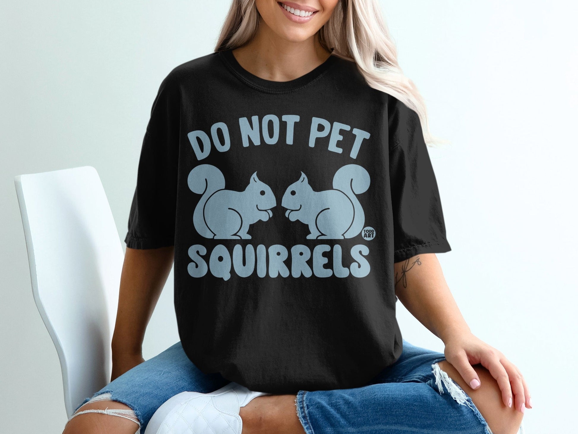 Black t-shirt with "DO NOT PET SQUIRRELS" and two cartoon squirrels.