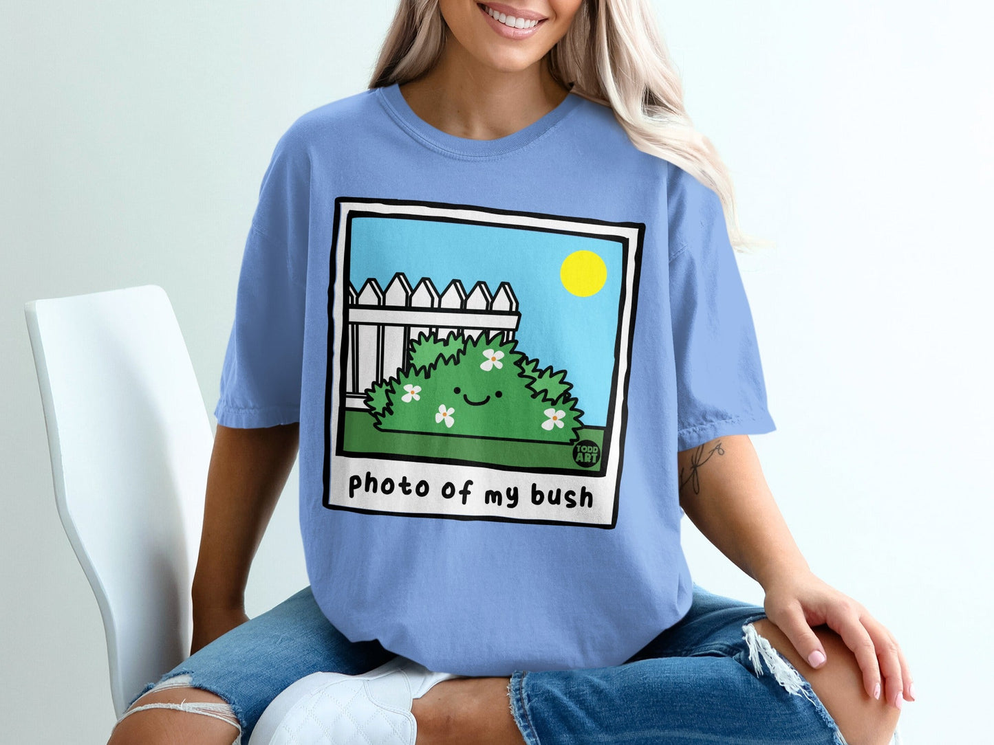 T-shirt with "photo of my bush" text and cartoon bush with smiling face.