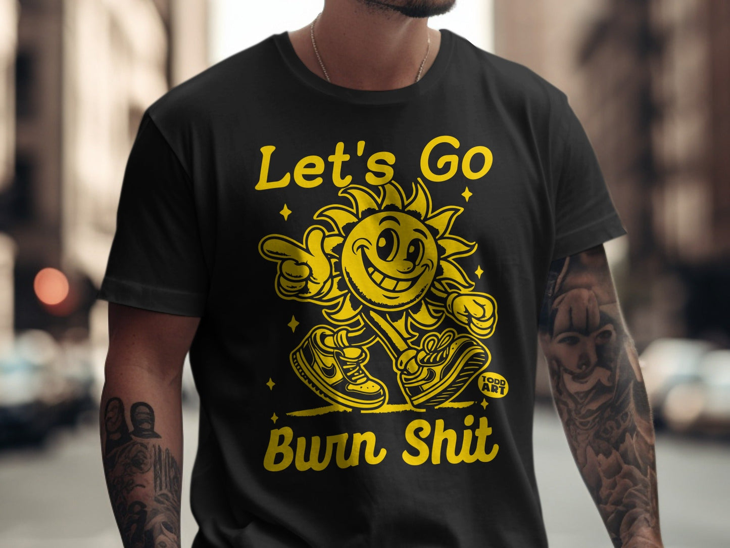 Black t-shirt with "Let's Go Burn Shit" text and smiling sun graphic.