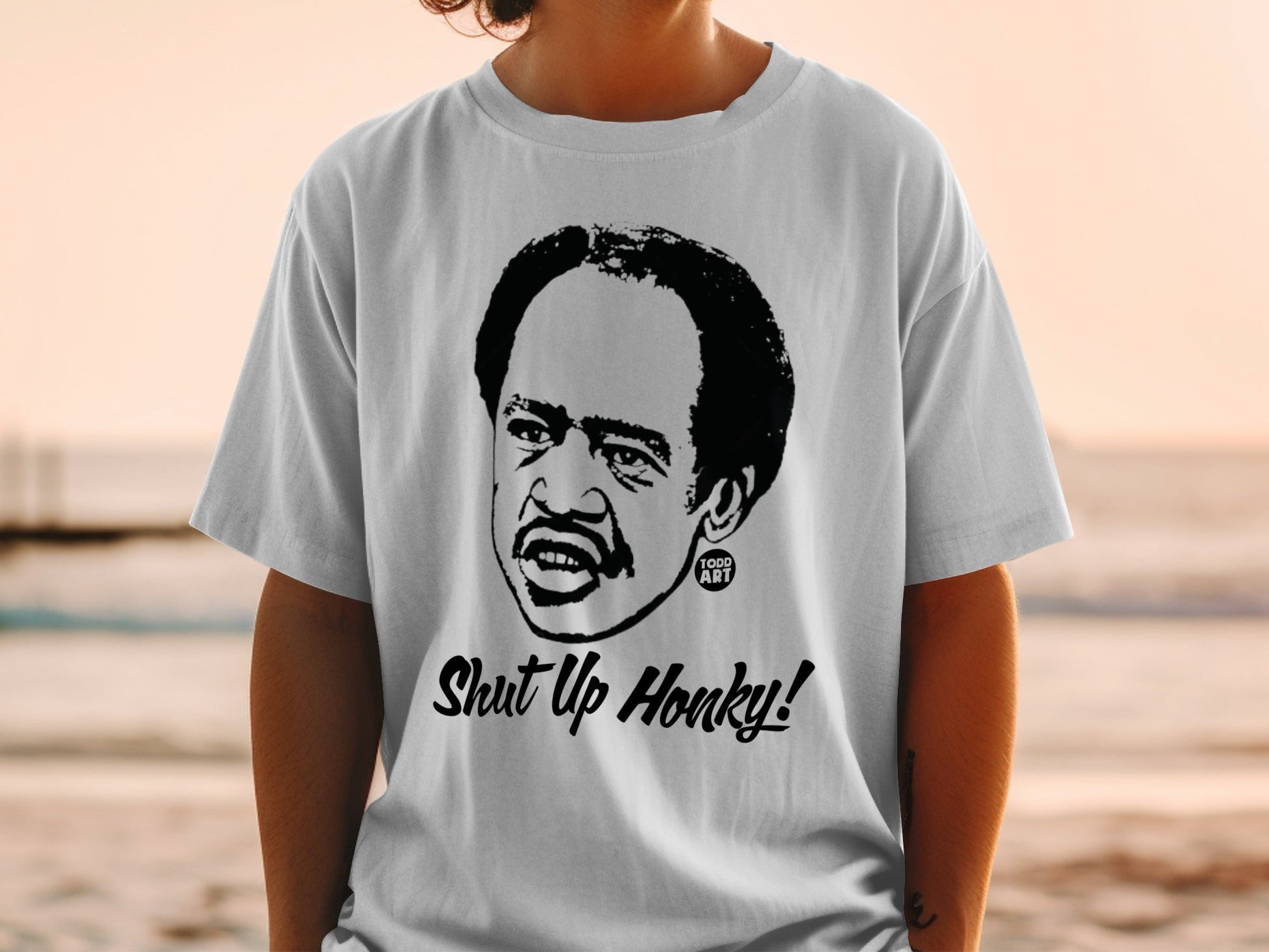 T-shirt with black graphic of Richard Pryor saying "Shut Up Honky!"