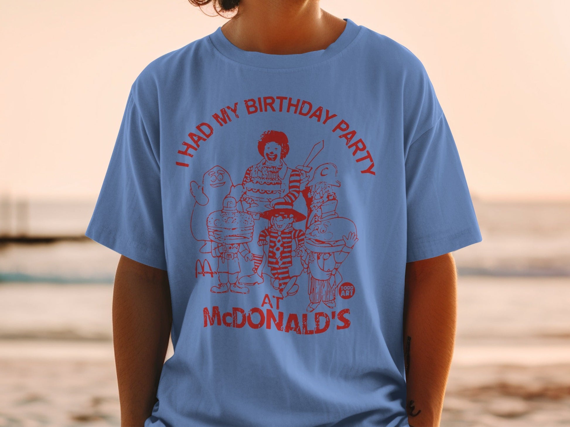 Blue t-shirt with red graphic of McDonald's characters and "I HAD MY BIRTHDAY PARTY AT MCDONALD'S."