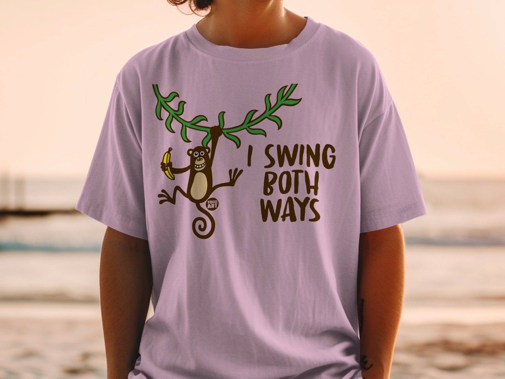 T-shirt with monkey holding banana, text "I SWING BOTH WAYS".