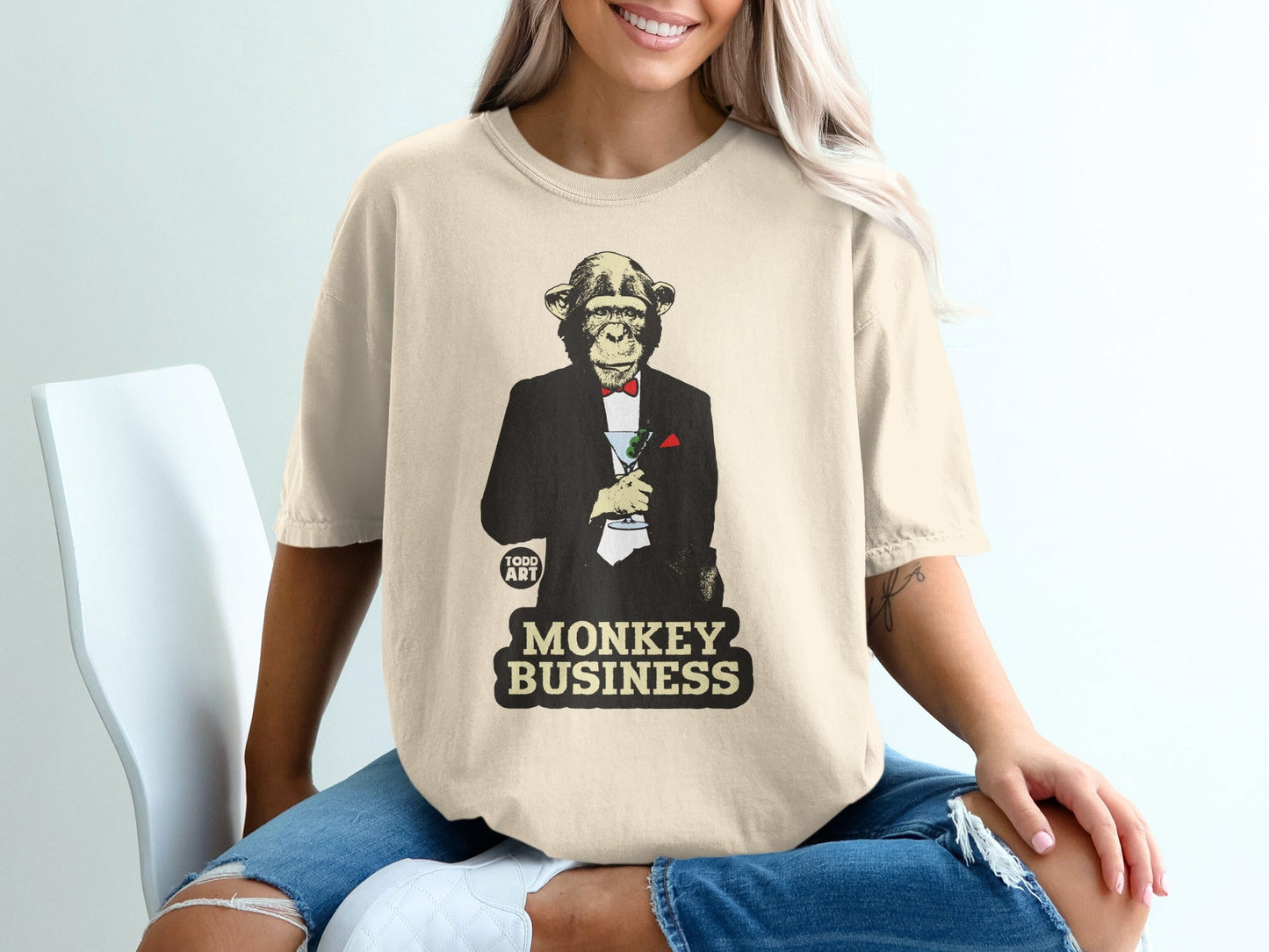 Monkey in tuxedo holding martini, with "MONKEY BUSINESS" text.