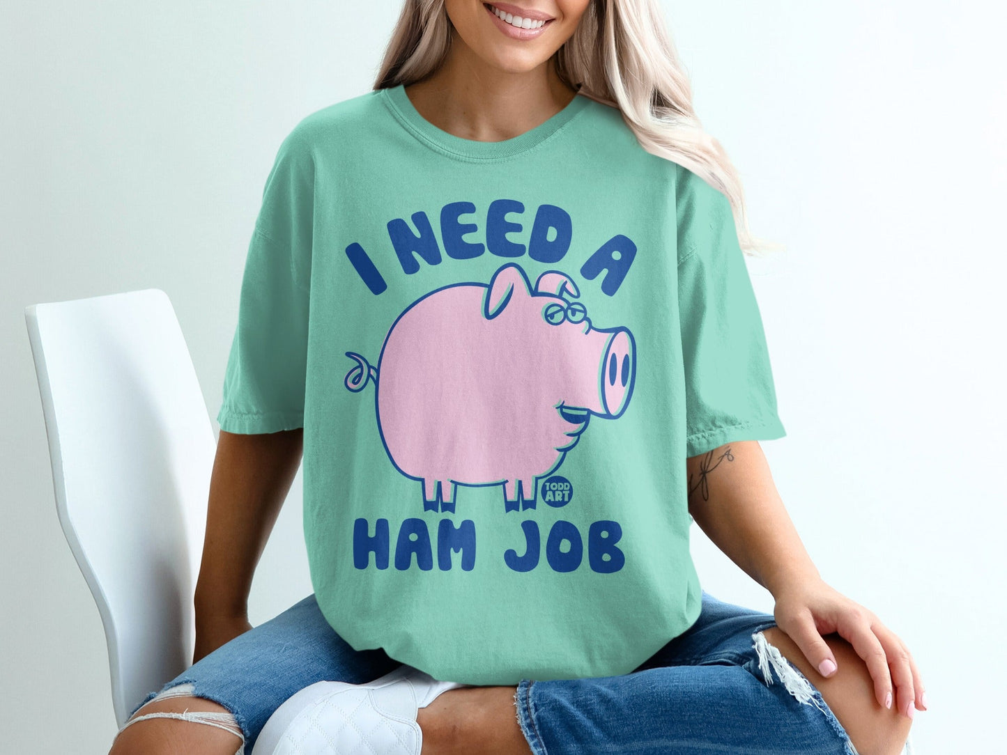 Mint t-shirt with pink pig graphic and text "I NEED A HAM JOB".