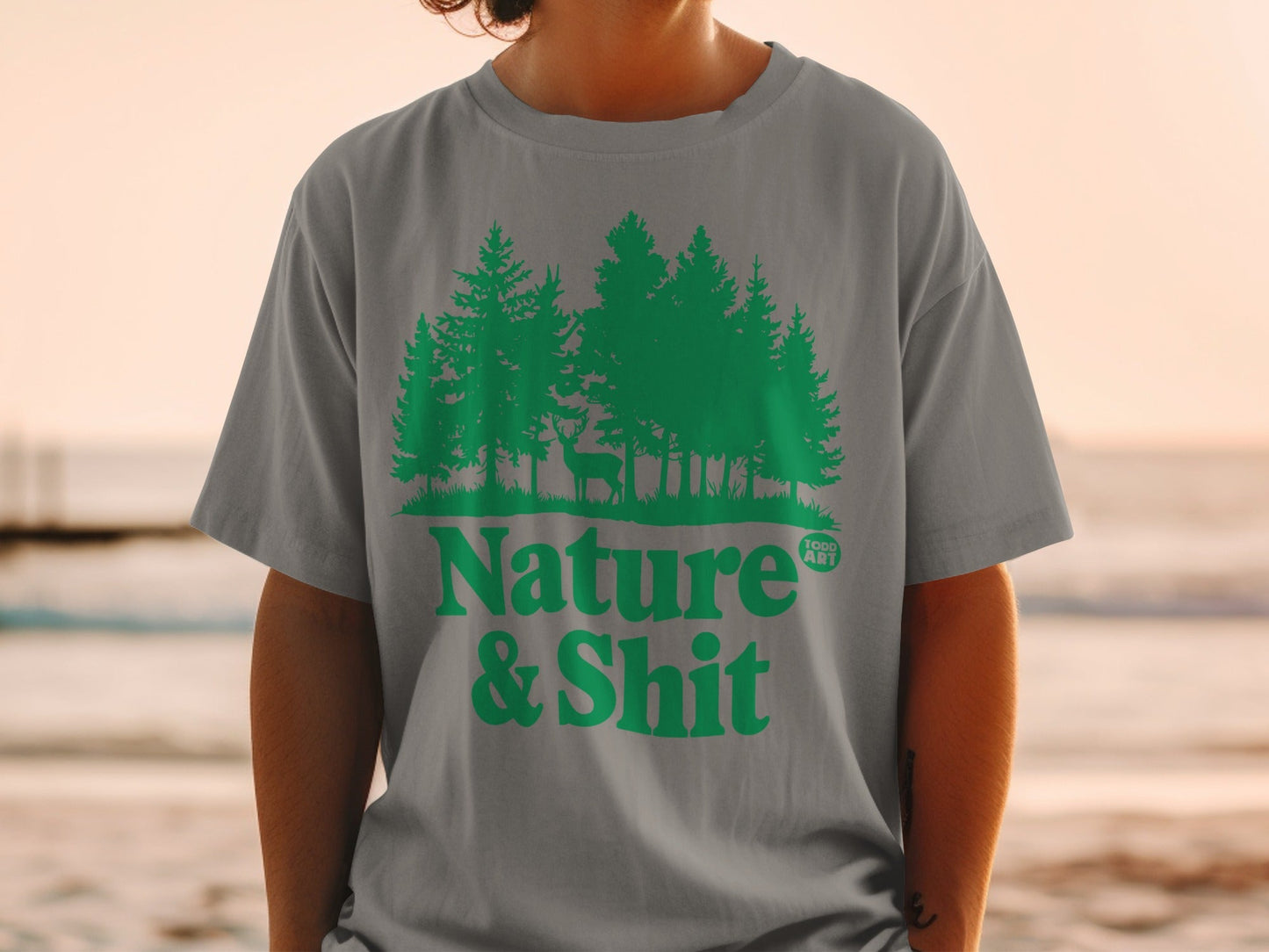 Gray t-shirt with "Nature & Shit" text and forest scene with deer.