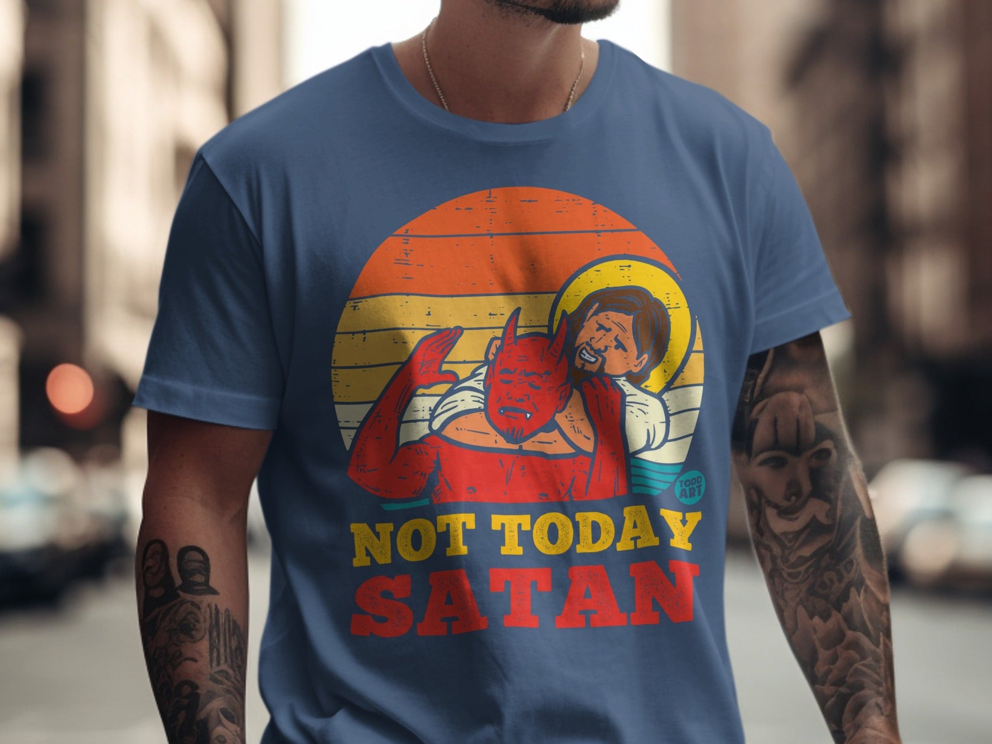 Blue t-shirt with graphic of devil on Jesus's back, text "NOT TODAY SATAN".